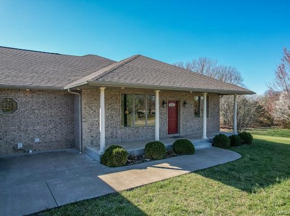 exterior space with a lawn and a porch