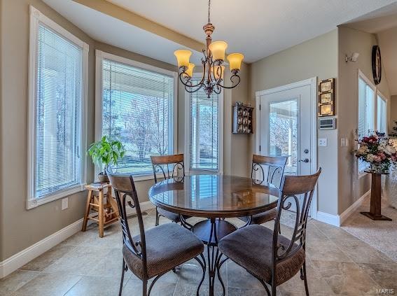 dining space with a notable chandelier