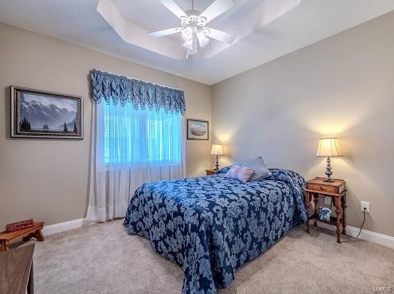 bedroom featuring light carpet and ceiling fan