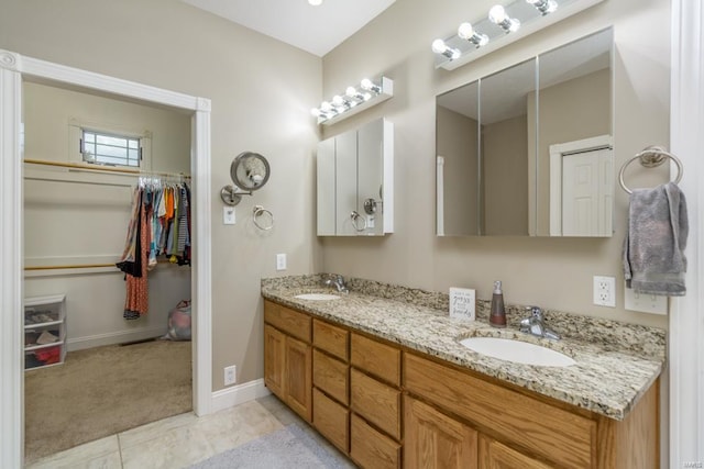 bathroom featuring tile patterned flooring and vanity