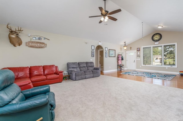 living room with lofted ceiling, ceiling fan, and hardwood / wood-style flooring