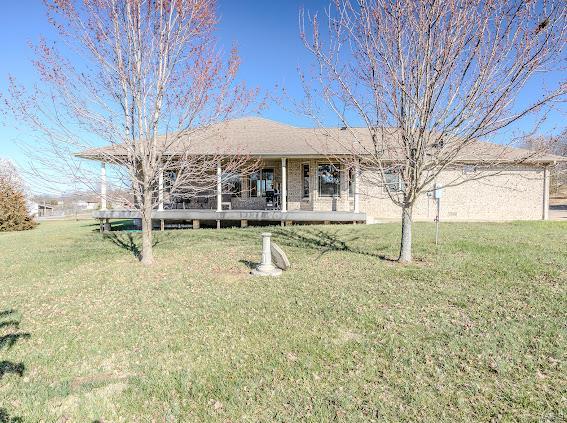 view of front of property with a front lawn and a deck