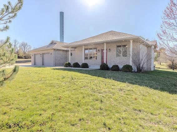 ranch-style house with a garage and a front yard