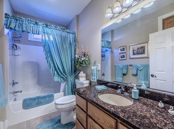 full bathroom featuring shower / tub combo, vanity, toilet, and tile patterned floors