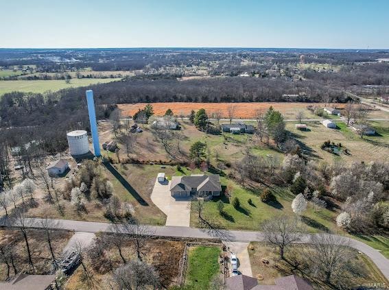 birds eye view of property with a rural view