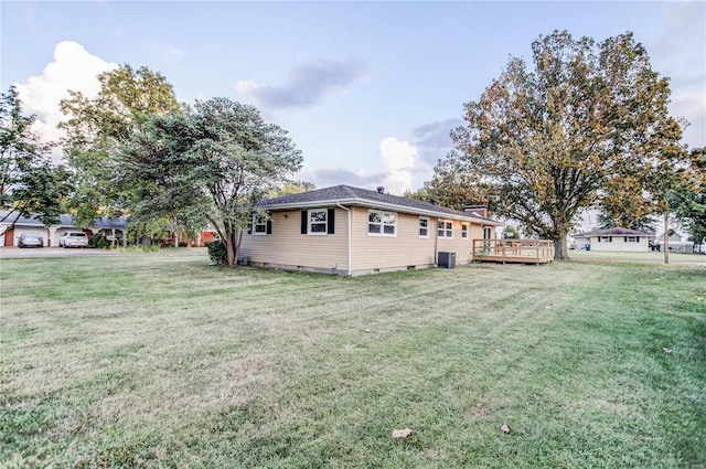 view of side of home with a lawn and a wooden deck