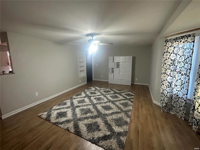 interior space featuring ceiling fan and dark wood-type flooring