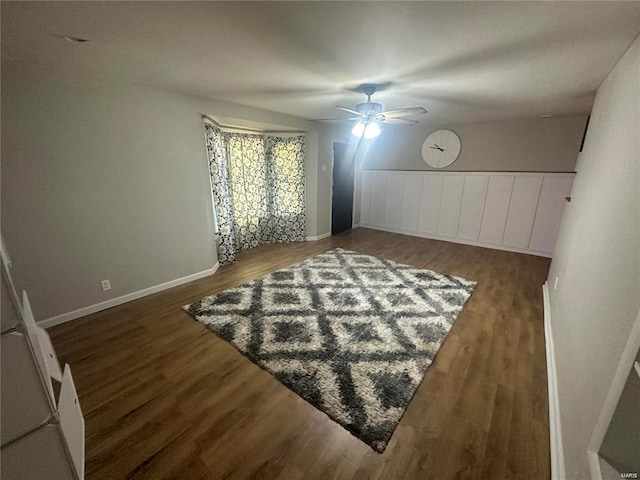 interior space with ceiling fan and dark hardwood / wood-style floors