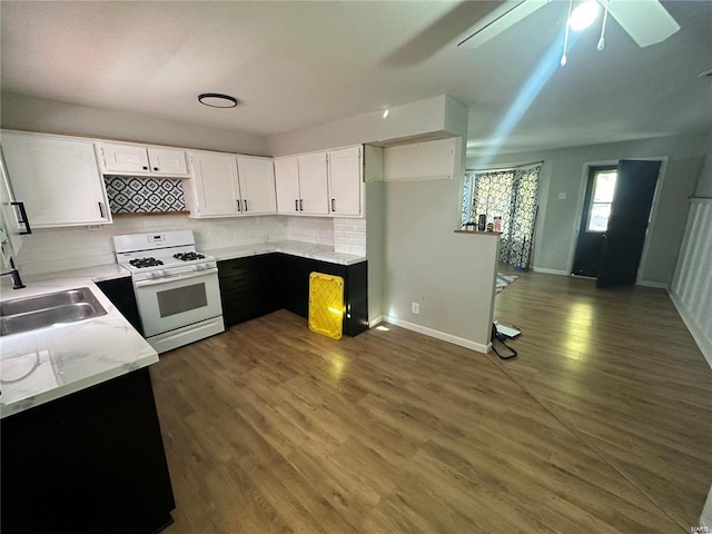 kitchen featuring white cabinets, ceiling fan, dark hardwood / wood-style floors, and white range with gas cooktop