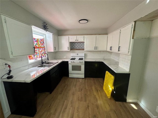 kitchen featuring light hardwood / wood-style flooring, white cabinets, white range with gas stovetop, and sink