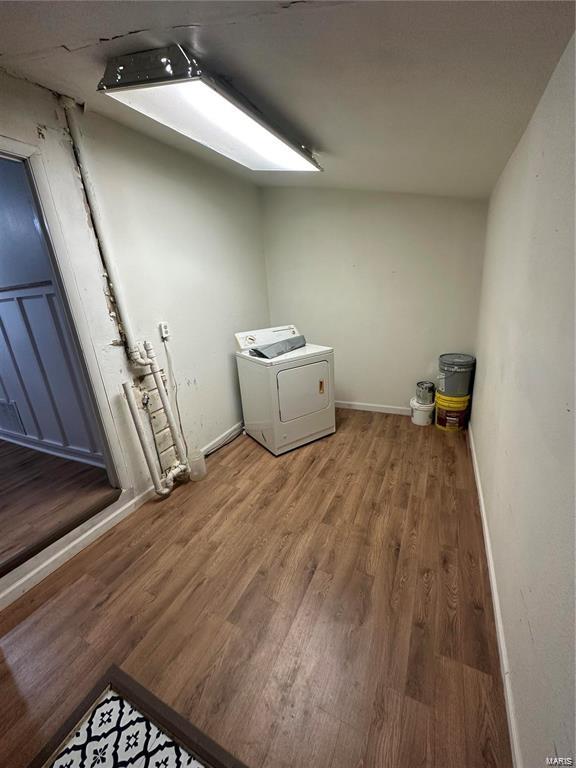 laundry room with hardwood / wood-style floors and washer / dryer