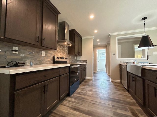 kitchen with black range with electric stovetop, ornamental molding, dark brown cabinets, wall chimney exhaust hood, and dark wood-type flooring