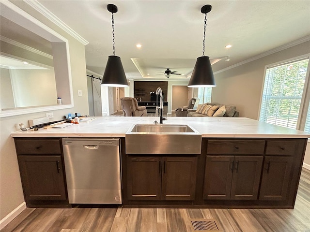 kitchen featuring dark brown cabinets, light wood-type flooring, sink, ceiling fan, and stainless steel dishwasher