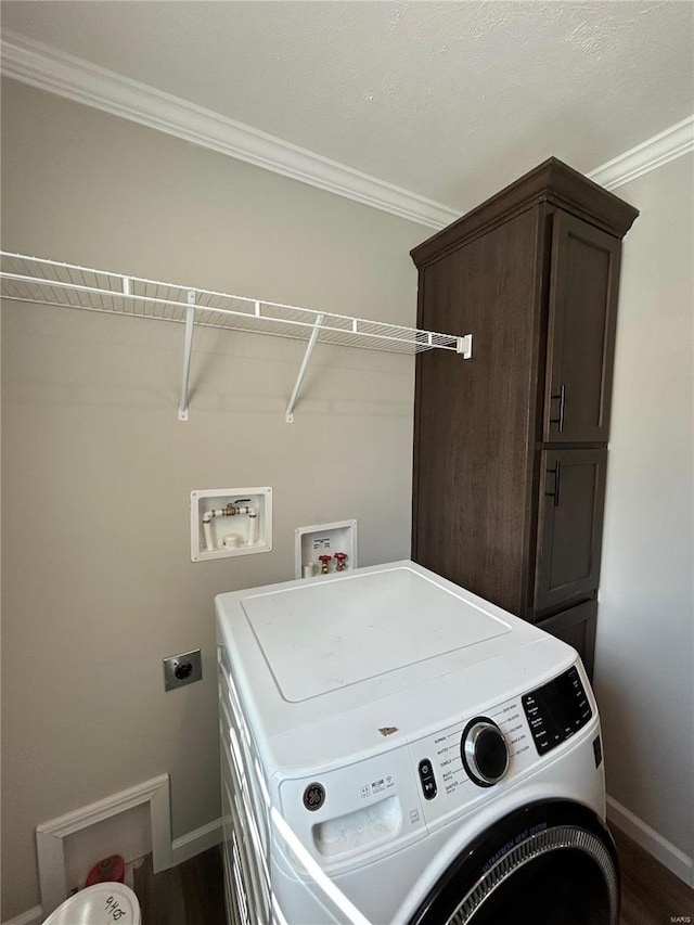 clothes washing area with cabinets, wood-type flooring, washer / dryer, and crown molding