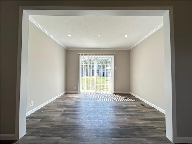 empty room featuring ornamental molding and dark hardwood / wood-style flooring