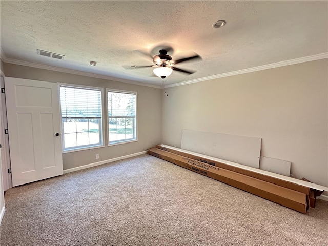 carpeted spare room with a textured ceiling, ceiling fan, and crown molding