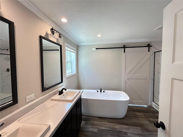 bathroom with wood-type flooring, crown molding, vanity, and separate shower and tub