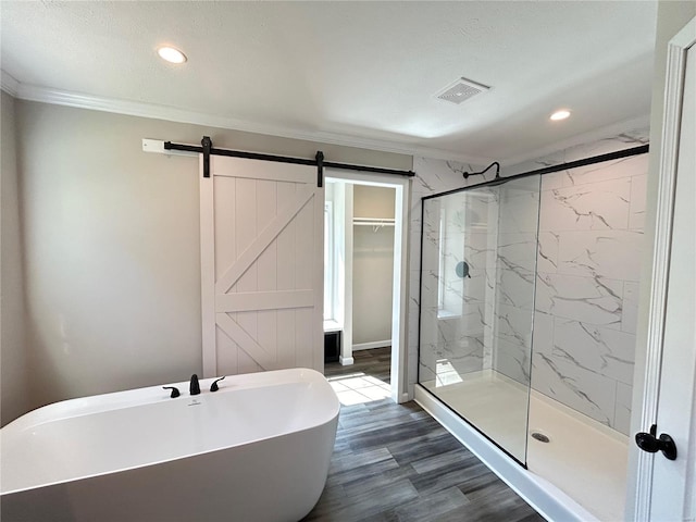 bathroom with ornamental molding, wood-type flooring, a textured ceiling, and independent shower and bath