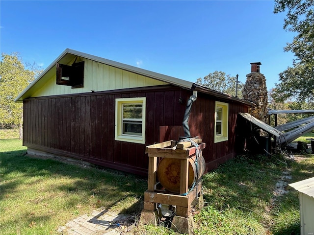 view of side of home featuring a yard