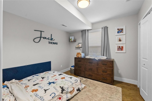 bedroom featuring dark colored carpet and a closet