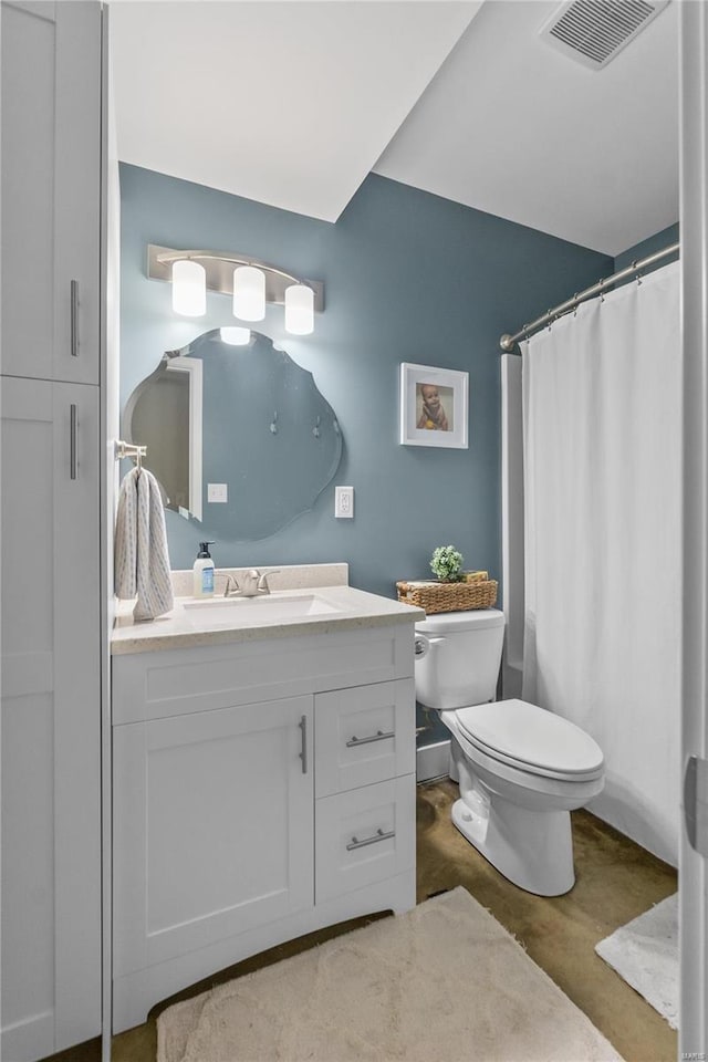 bathroom featuring vanity, toilet, and a shower with shower curtain