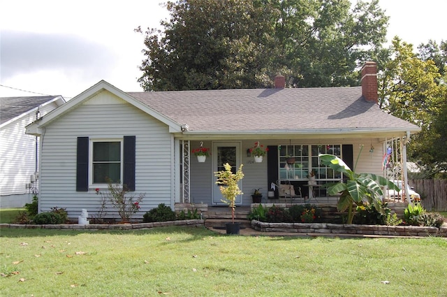 view of front of home featuring covered porch and a front yard