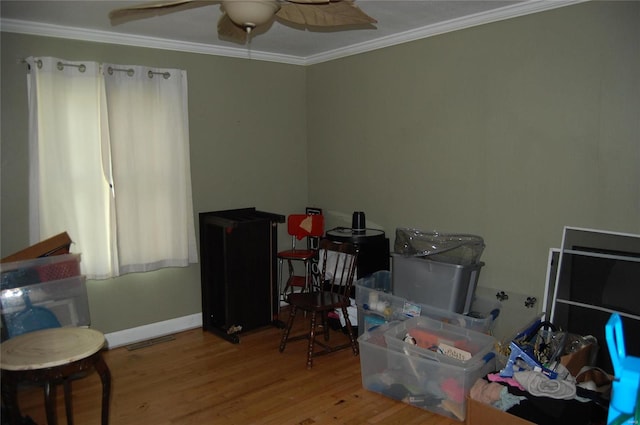 miscellaneous room with ceiling fan, crown molding, and wood-type flooring