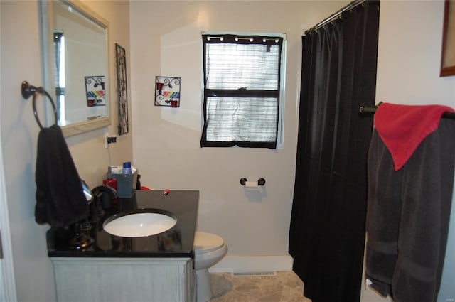 bathroom with vanity, toilet, and tile patterned floors