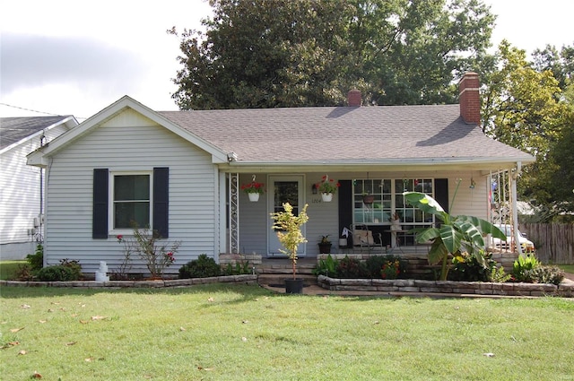 view of front facade with a front lawn and covered porch