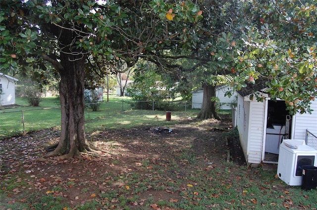 view of yard featuring an outdoor structure and ac unit