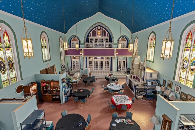 interior space with carpet floors, a wealth of natural light, and high vaulted ceiling