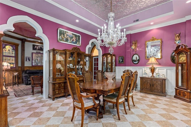 dining room featuring ornamental molding and a chandelier