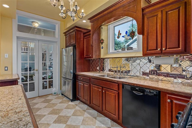 kitchen featuring pendant lighting, dishwasher, a chandelier, sink, and stainless steel refrigerator