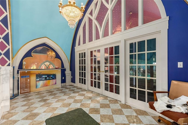 exterior space with french doors and a chandelier