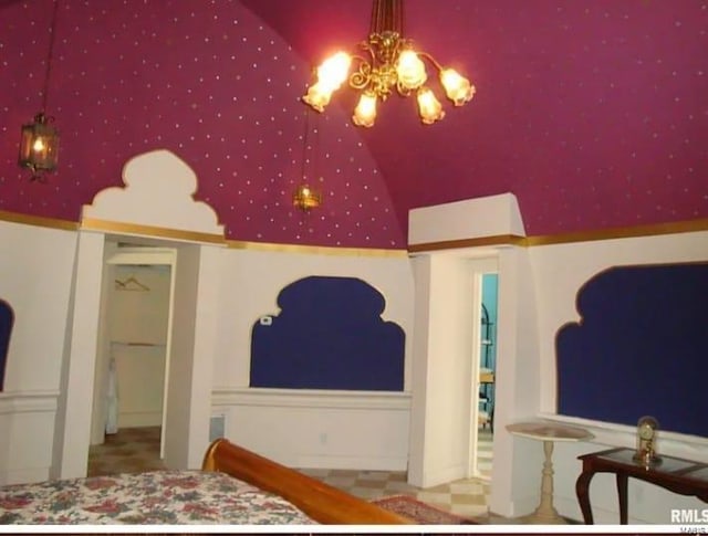 bedroom featuring an inviting chandelier and vaulted ceiling