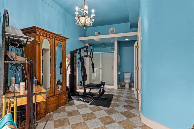 exercise area featuring a notable chandelier