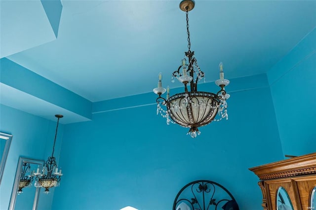 interior details featuring an inviting chandelier