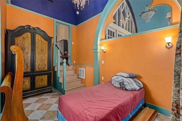 bedroom featuring an inviting chandelier and high vaulted ceiling