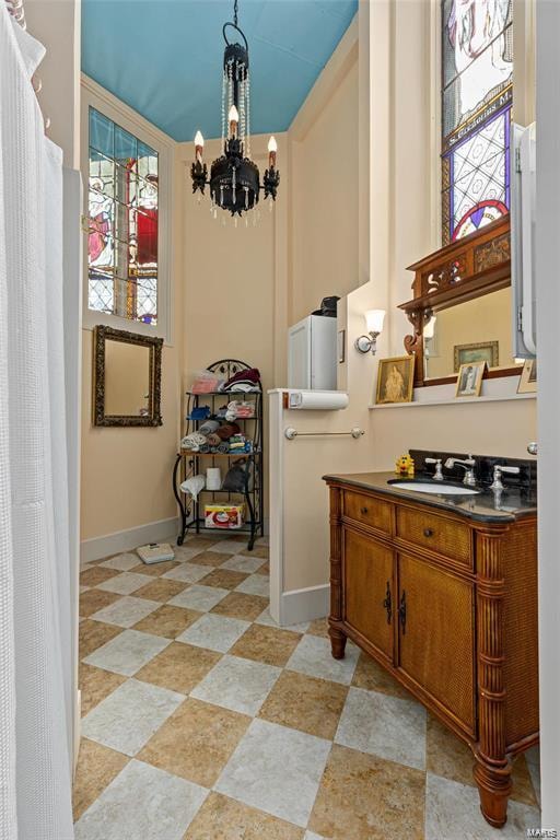 kitchen with sink, pendant lighting, and a notable chandelier