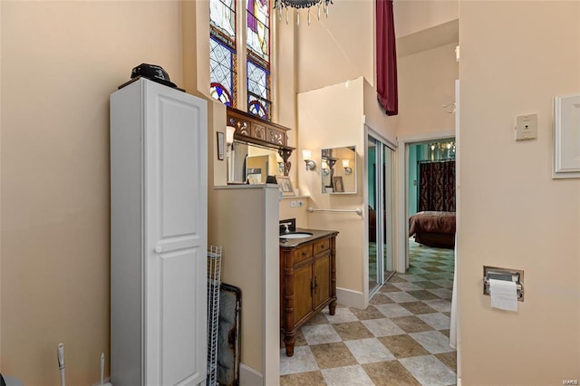 bathroom with vanity and a towering ceiling