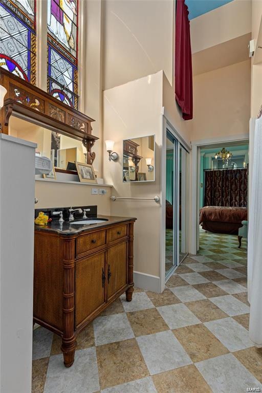 interior space with a high ceiling and vanity