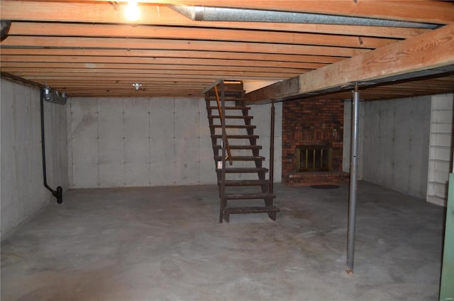 basement featuring a brick fireplace