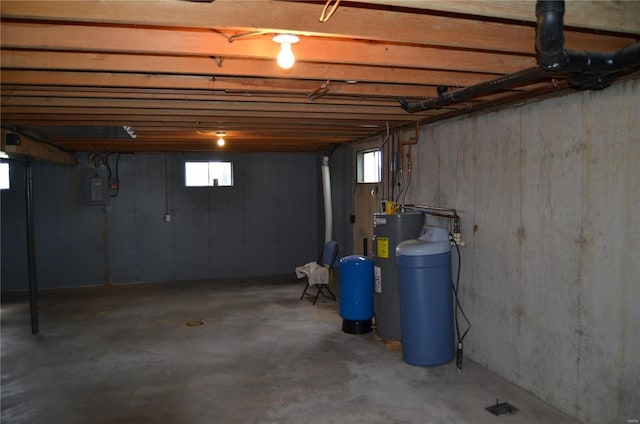 basement featuring water heater and electric panel