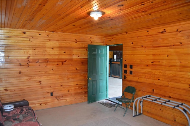 interior space with wood ceiling, wood walls, and light carpet