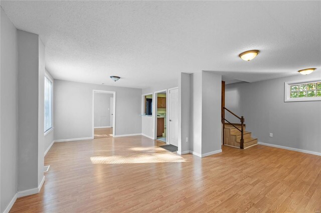 interior space featuring a textured ceiling and light hardwood / wood-style flooring