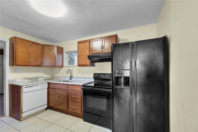 kitchen featuring black appliances, a textured ceiling, light tile patterned floors, and sink