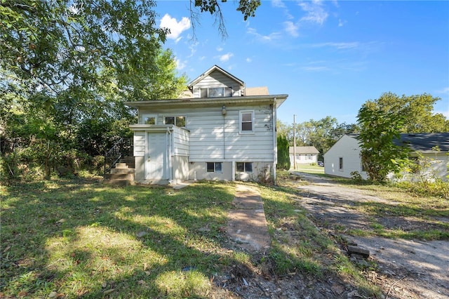 back of house with a yard