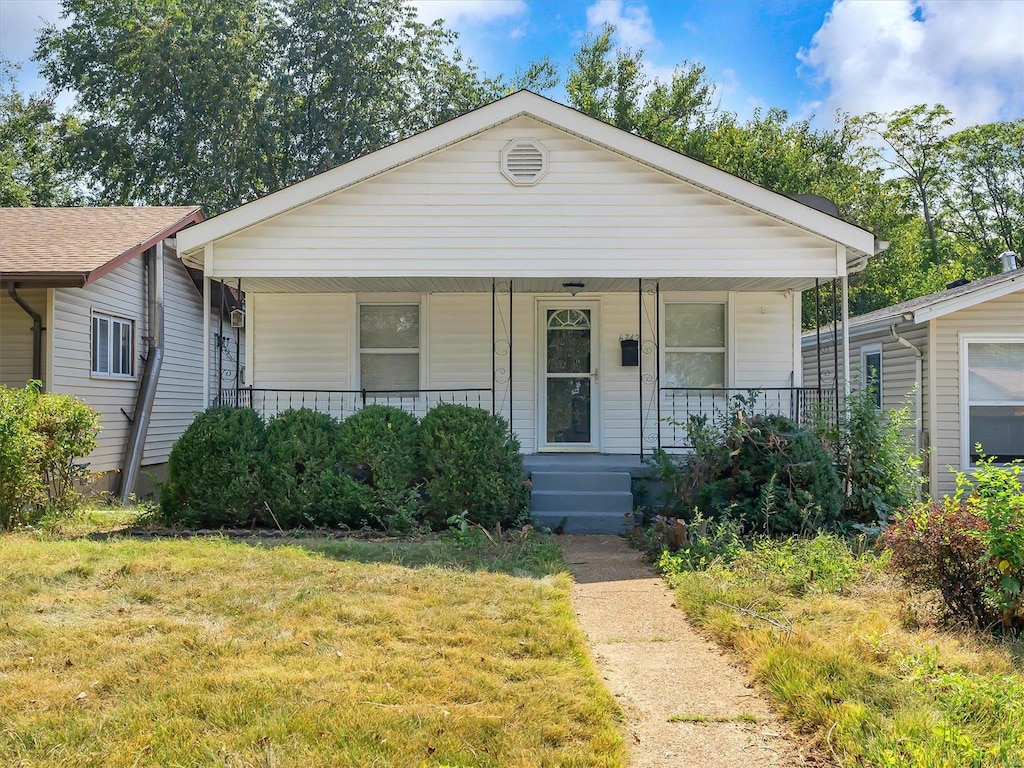 view of front of house with a front lawn and a porch