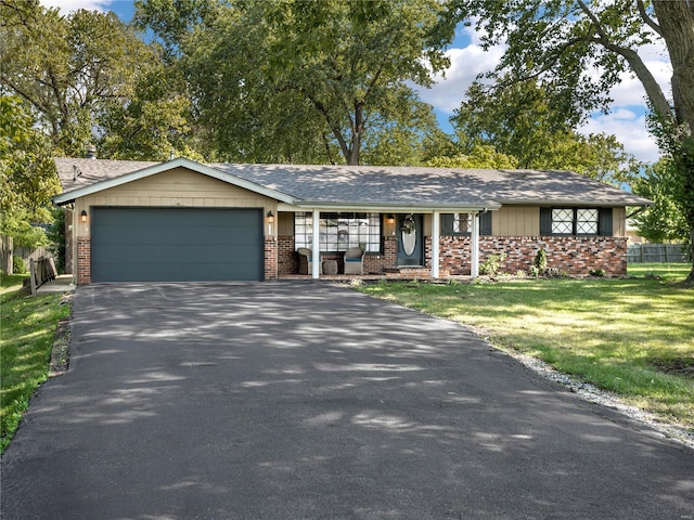 ranch-style home featuring a front yard and a garage