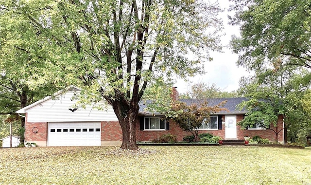 single story home with a front yard and a garage